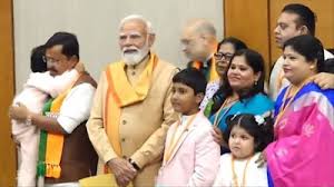 Newly elected BJP national president Nitin Nabin with his family members and PM Narendra Modi